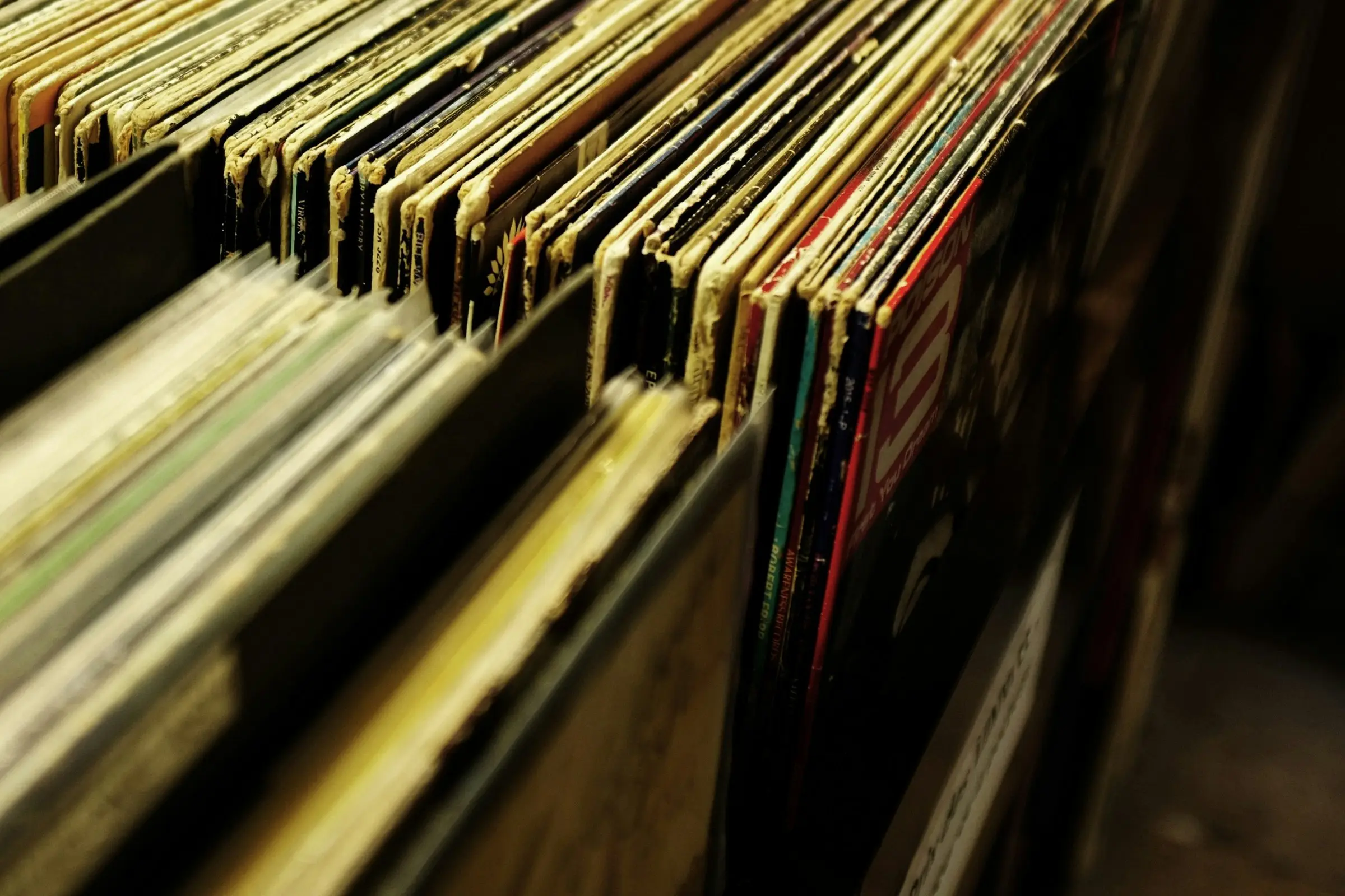 Bins of well-worn vinyl records in a record store, shallow focus